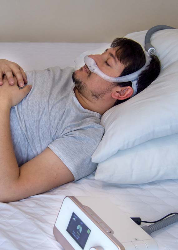 man with cpap resting